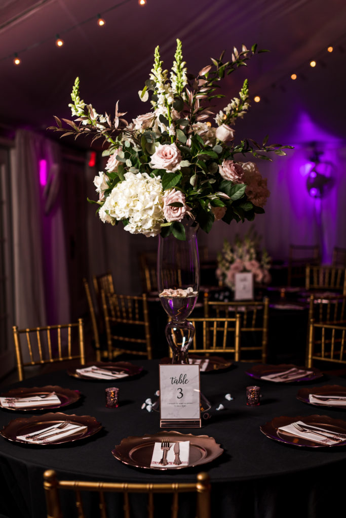 mankin mansion wedding table centerpiece with tall vase of white and pink flowers