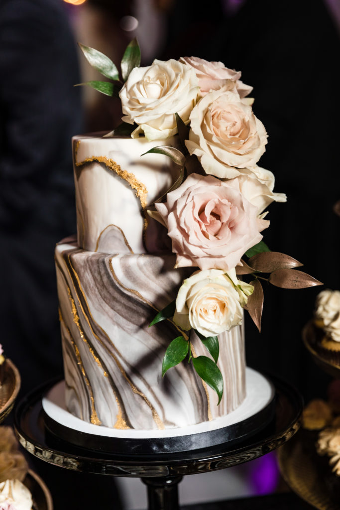white and black marble wedding cake with white flowers on mankin mansion wedding day