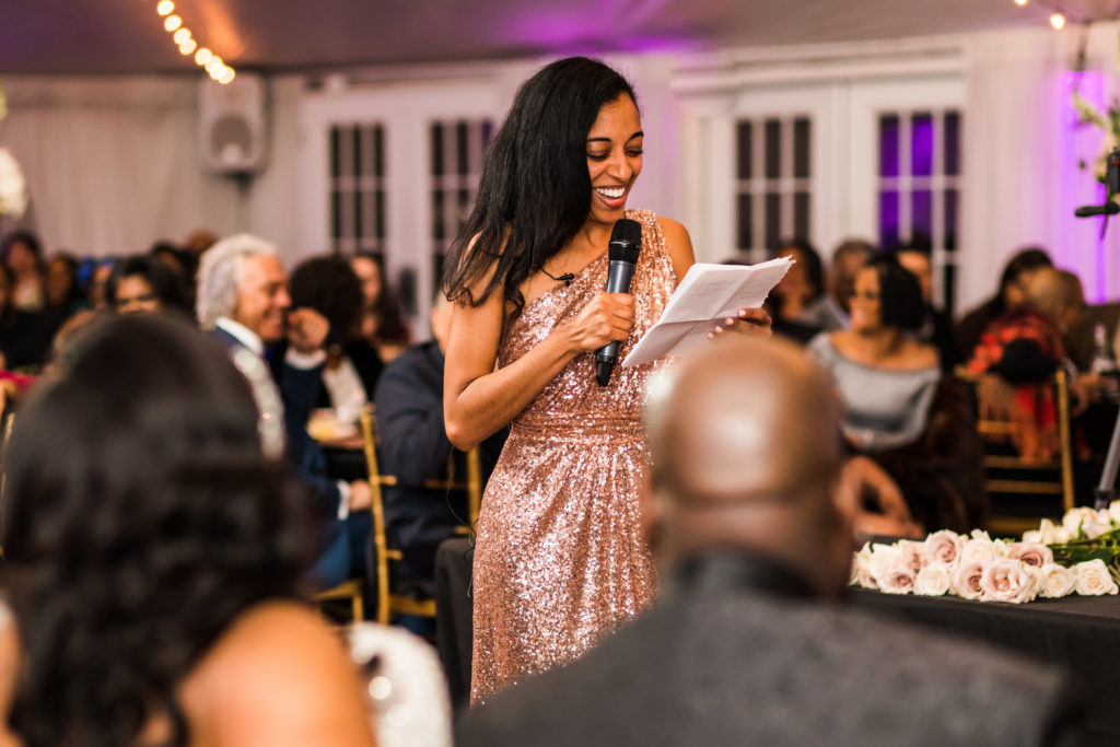 bridesmaid giving speech wearing rose gold sparkly dress at new year's eve wedding