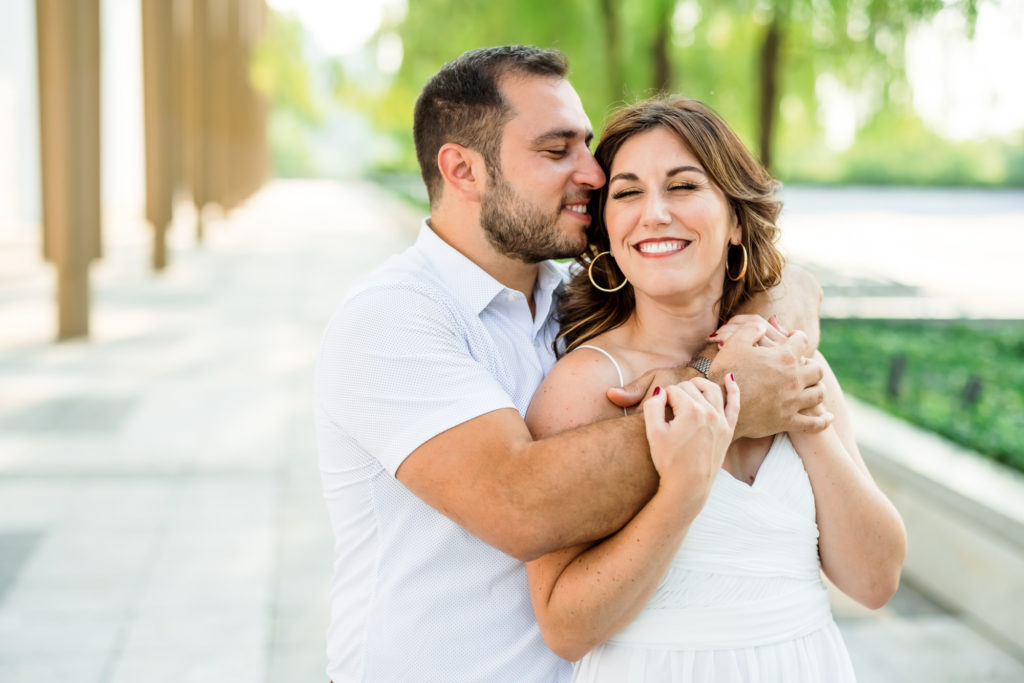 man hugging woman during outdoor engagement session
