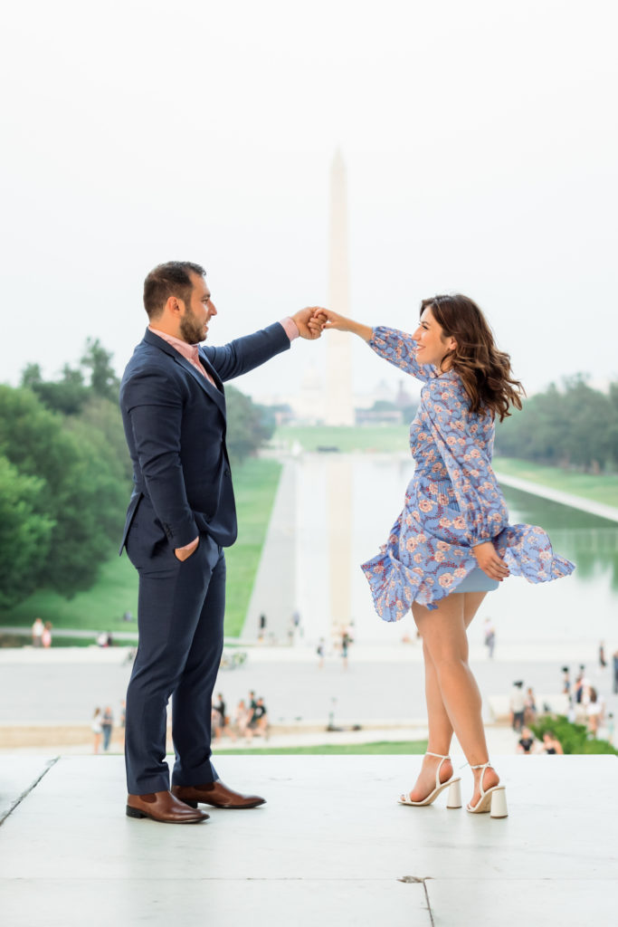 man spinning woman during engagement session at kennedy center