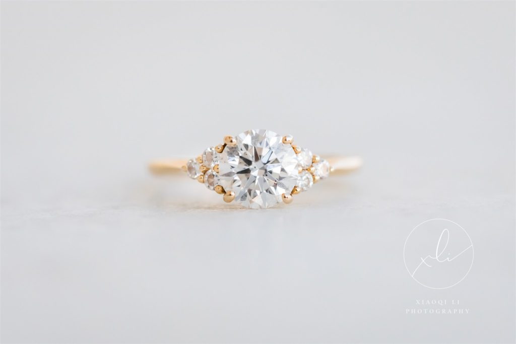 detail shot of engagement ring with gold ring and center diamond