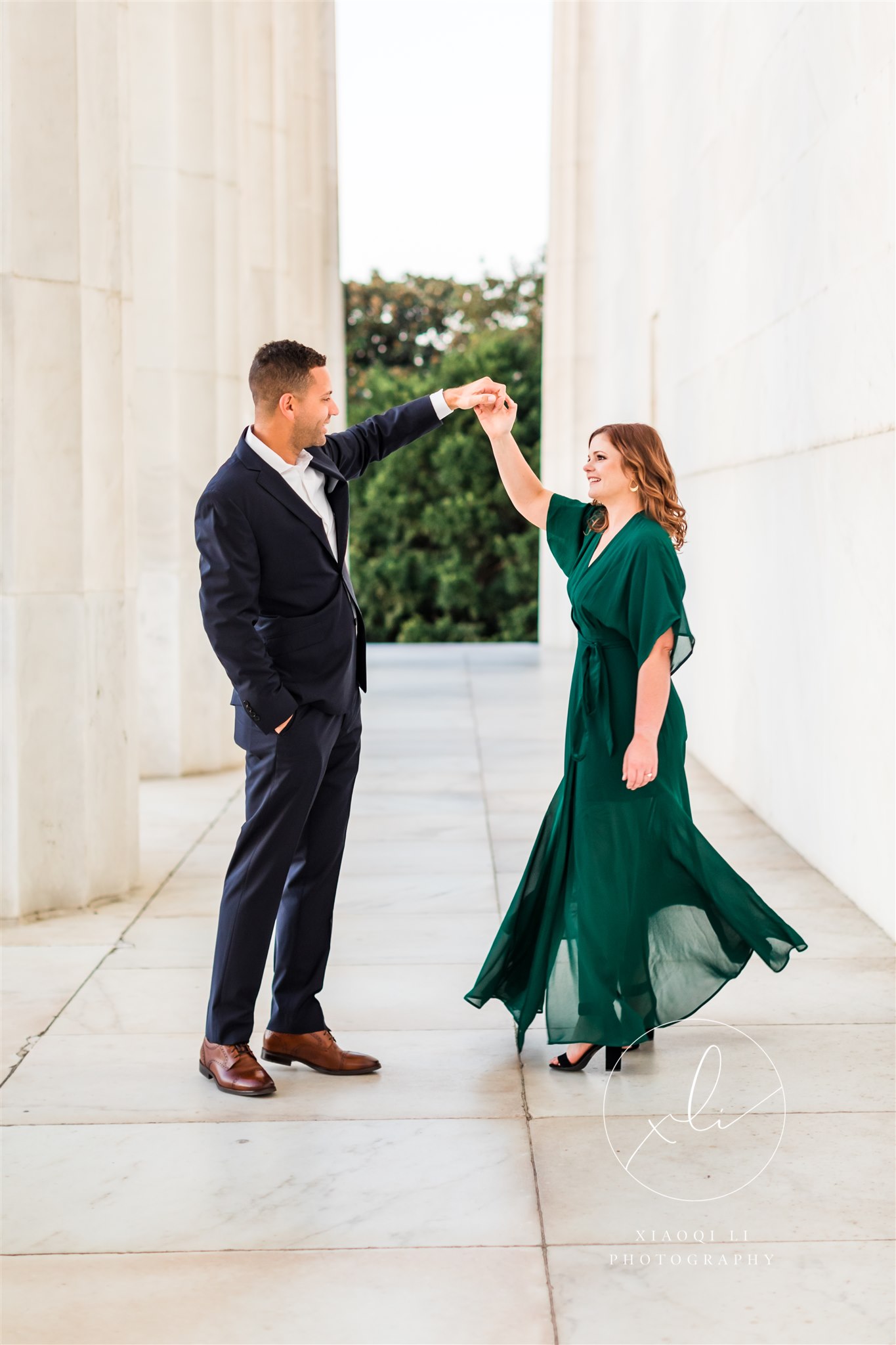 man and woman dressed in formal attire dancing together at Lincoln Memorial