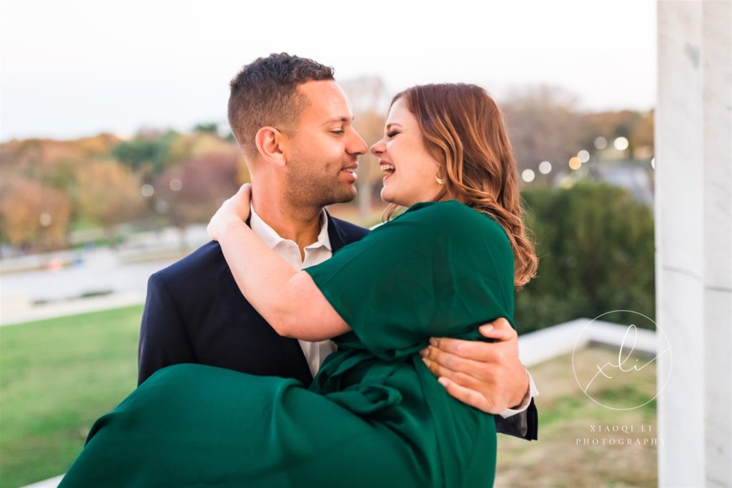 man lifting woman and spinning around at fall dc engagement session