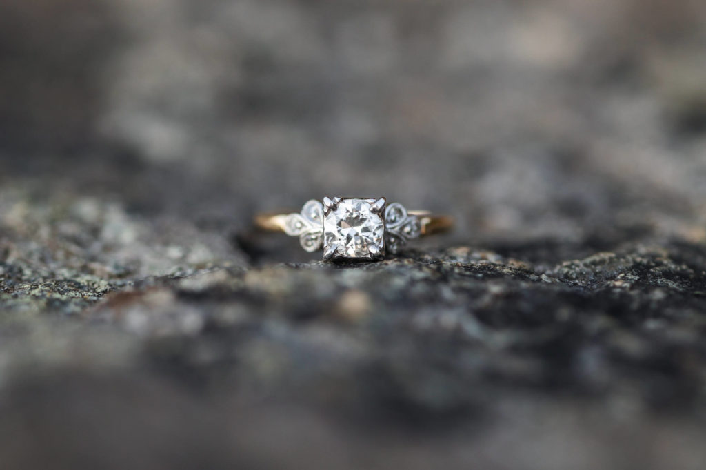 detail shot of engagement ring on rock at Ravens Roost