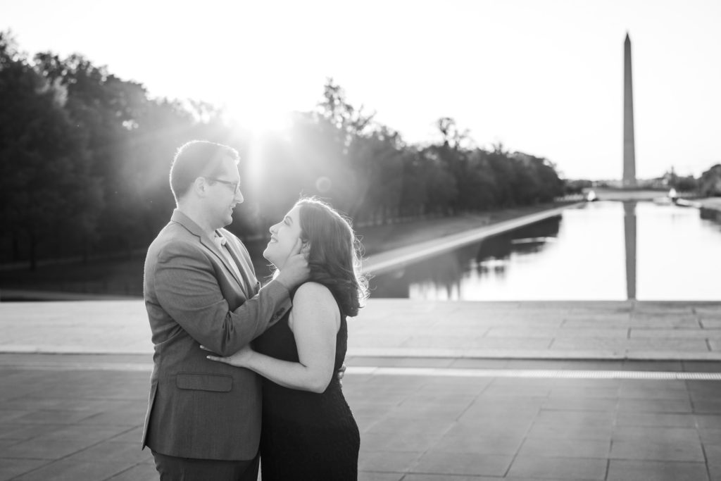 newly engaged couple hugging and celebrating during their Lincoln Memorial engagement session