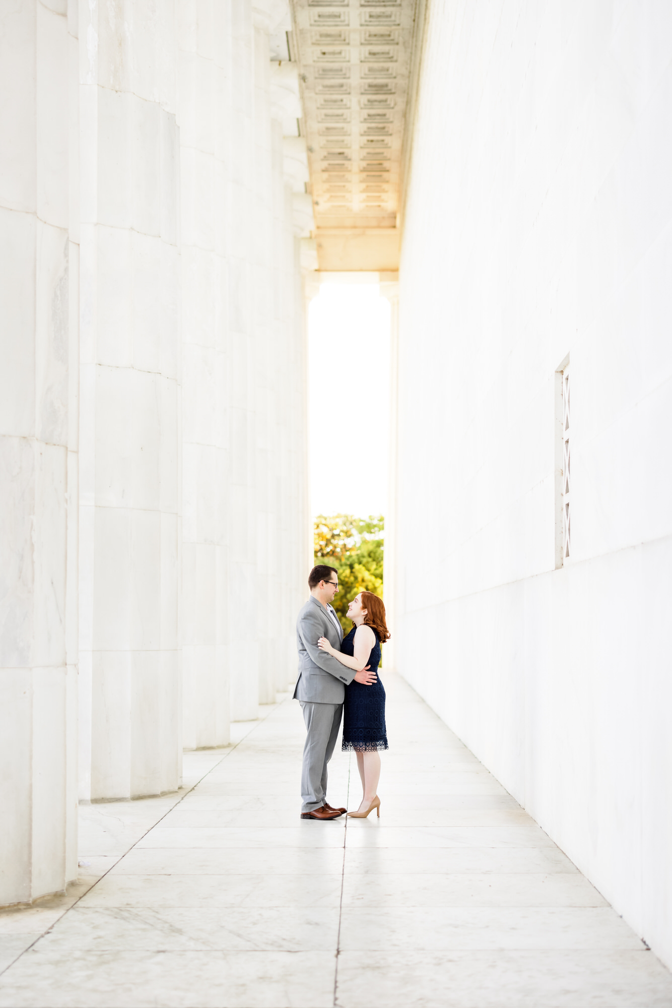 newly engaged couple holding one another at Lincoln Memorial in Washington DC