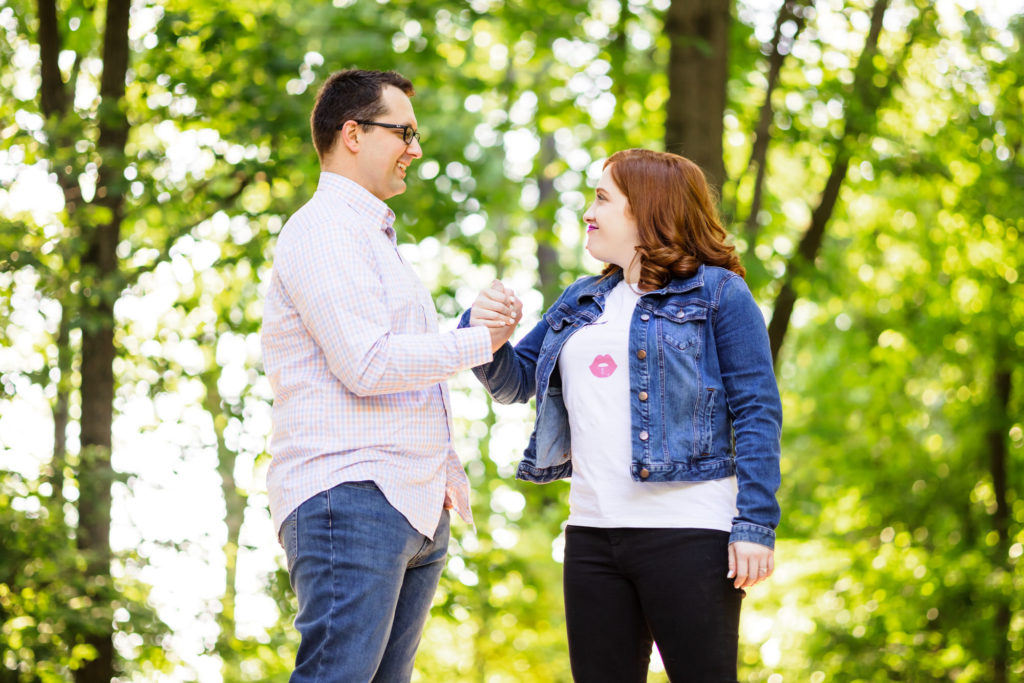 engaged couple fist bumping during outdoor engagement session