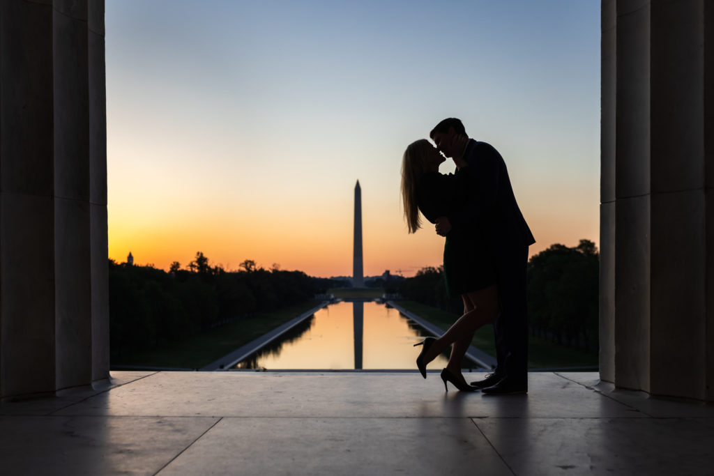 couple kissing and celebrating recent engagement during sunrise dc engagement session