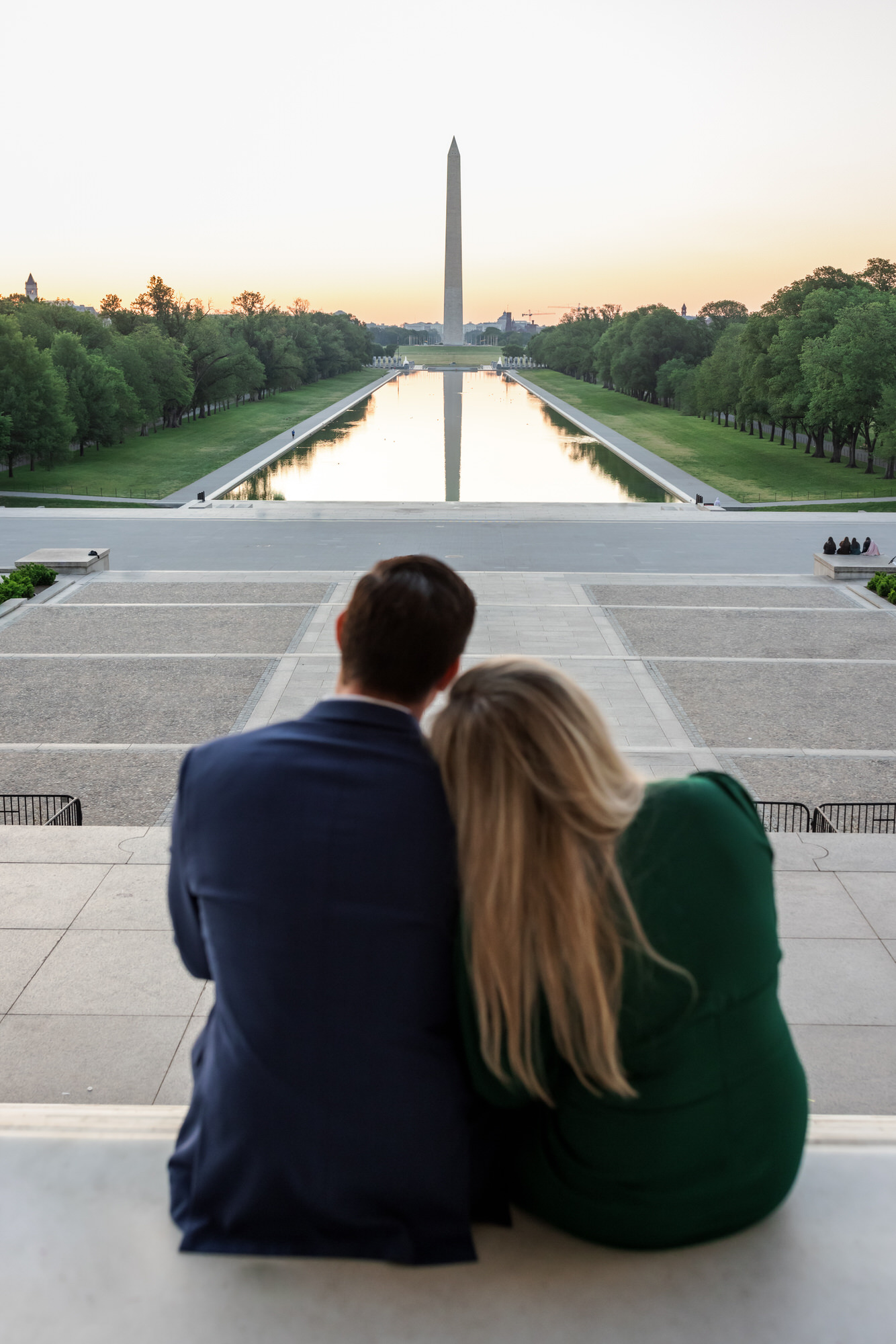 man and woman sitting together watching sunrise in DC