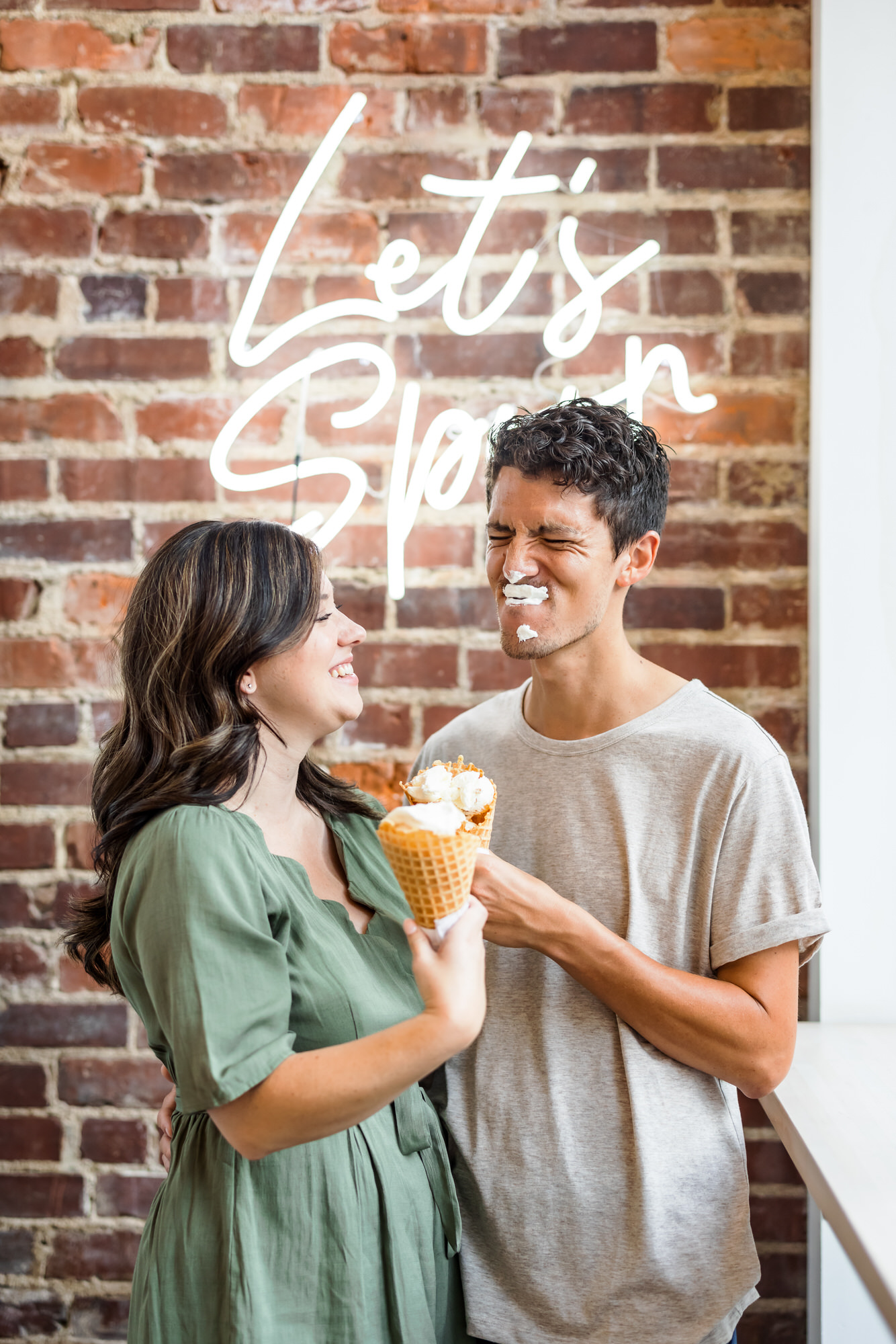 engaged couple eating ice cream at Scoop RVA during engagement session