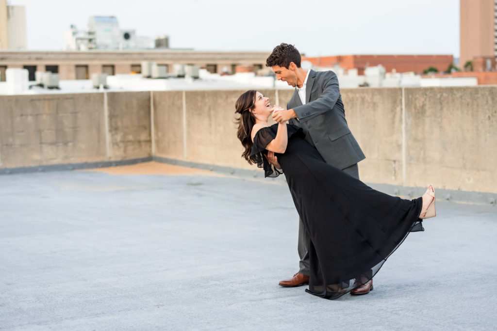 couple dancing together on rooftop during engagement session