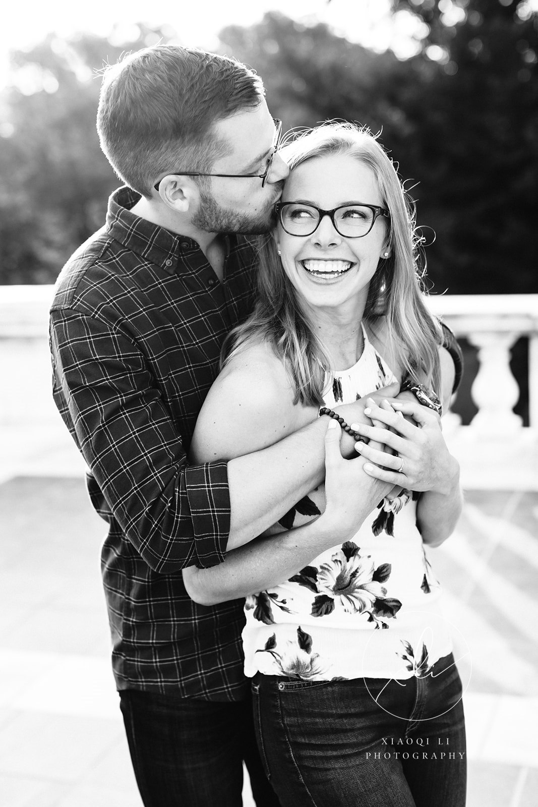 engaged couple hugging while man kisses woman's cheek during fall university of virginia engagement session