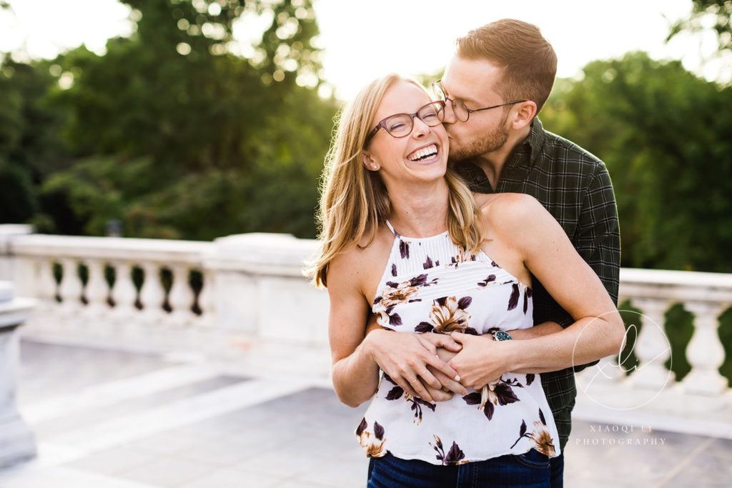 man and woman hugging and laughing together during fall university of virginia engagement session