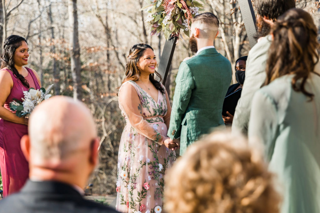 bride looking at groom during woodland chic outdoor ceremony