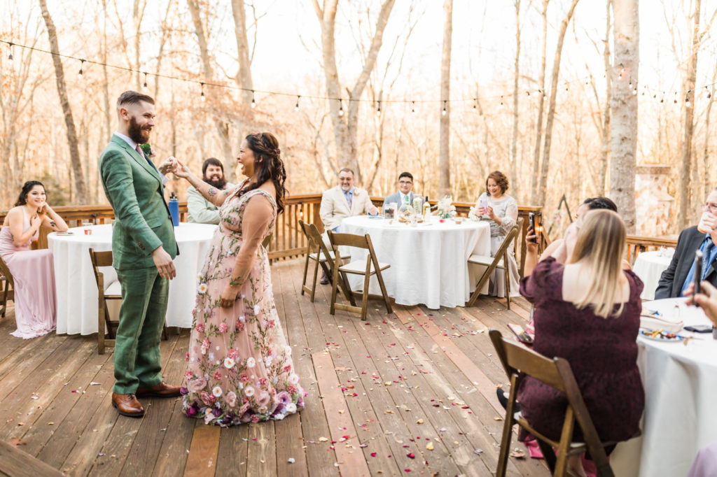 bride and groom dancing together during first dance at woodland chic airbnb wedding