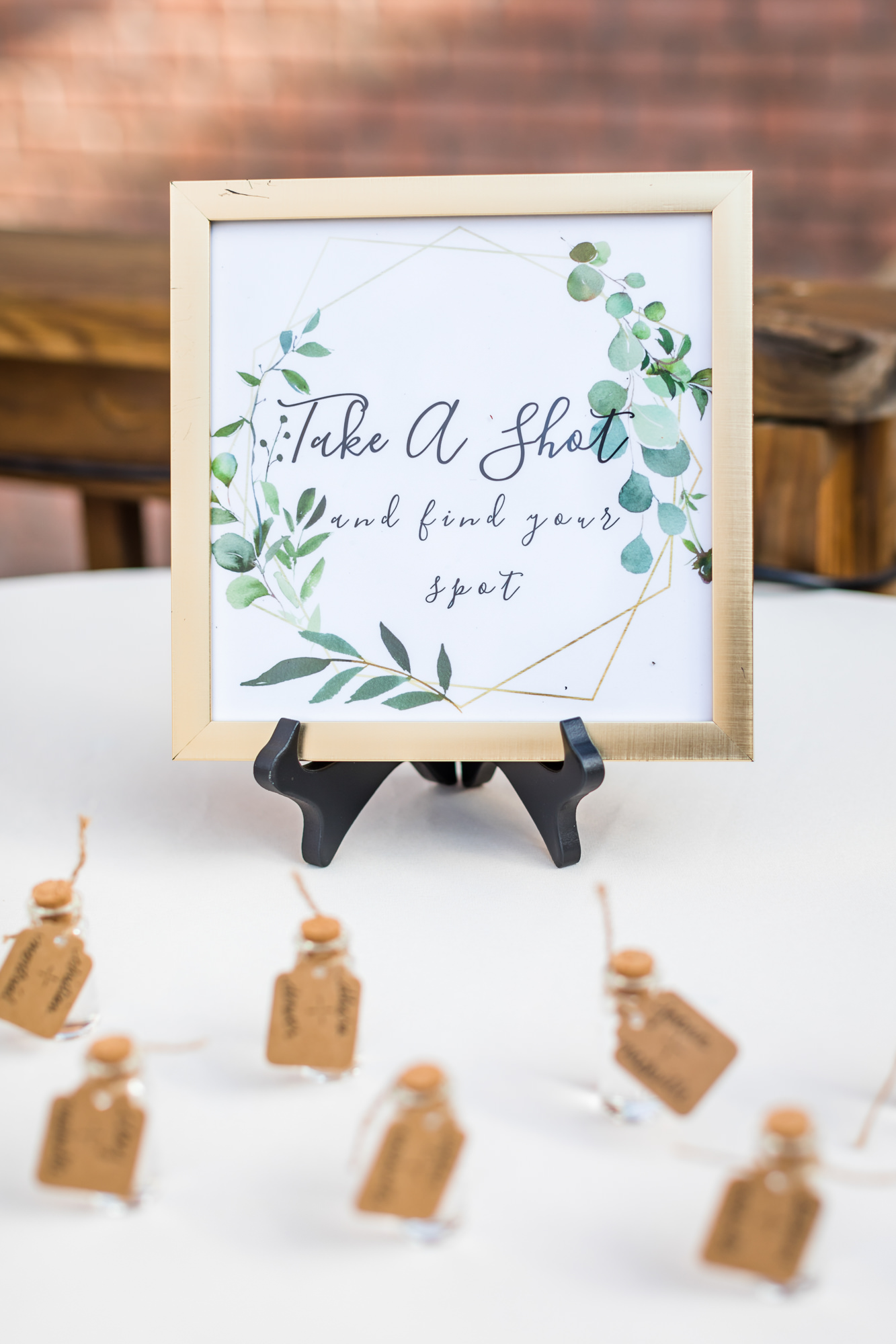 'take a shot' wedding sign with greenery and chic wedding reception
