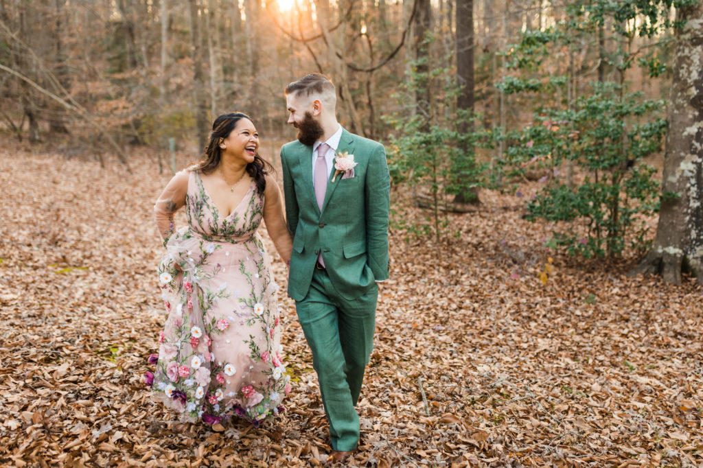 wedding couple walking in forest during bridal portraits on woodland chic airbnb wedding day