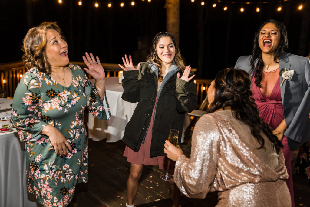 bride dancing with wedding guests during outdoor reception