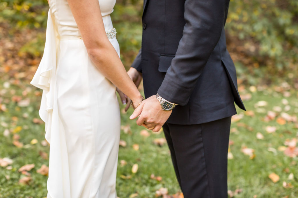 bridal couple holding hands after first look at house mountain inn wedding