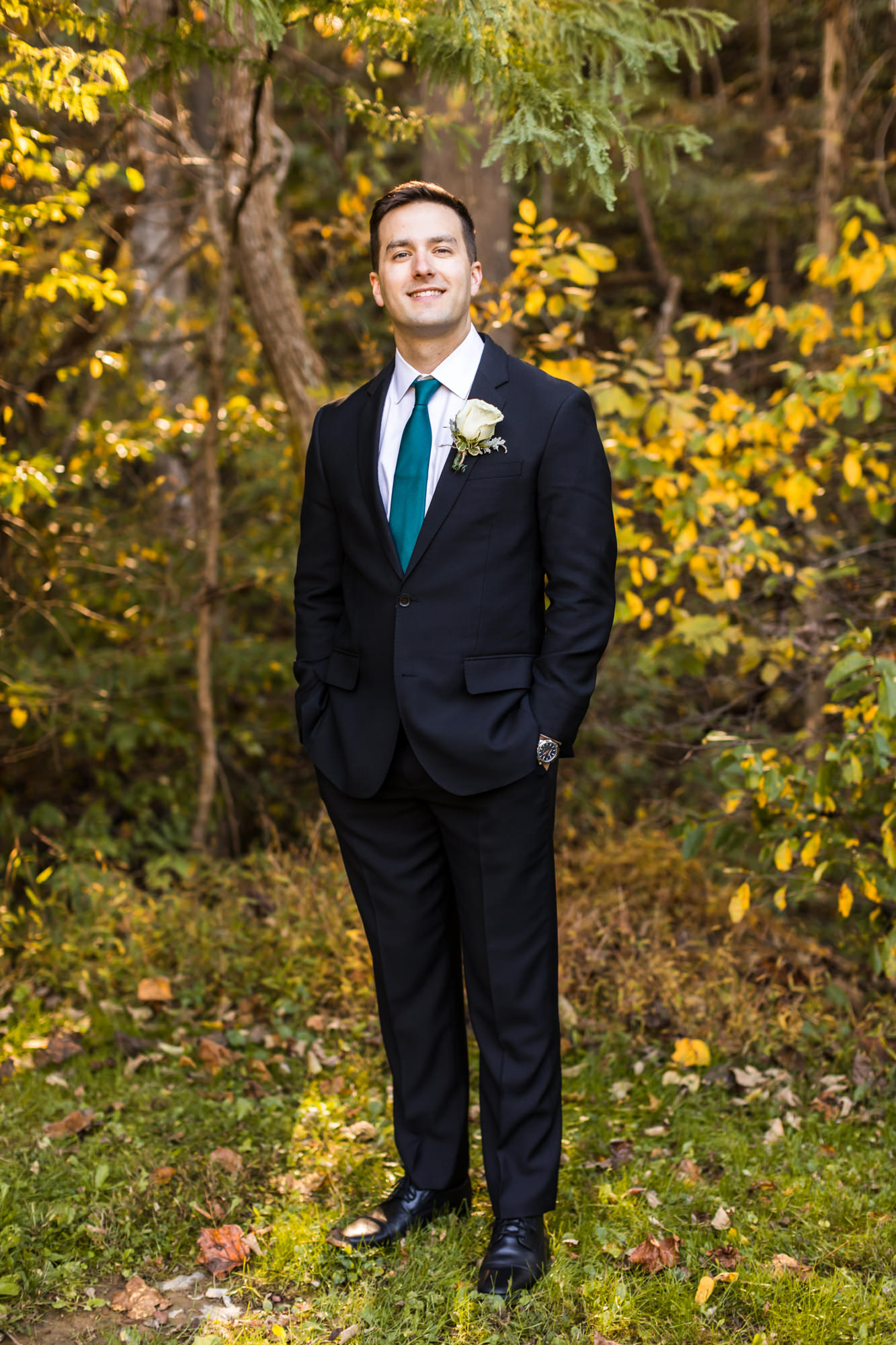 groom standing with hand's in pockets during bridal portraits at house mountain inn wedding