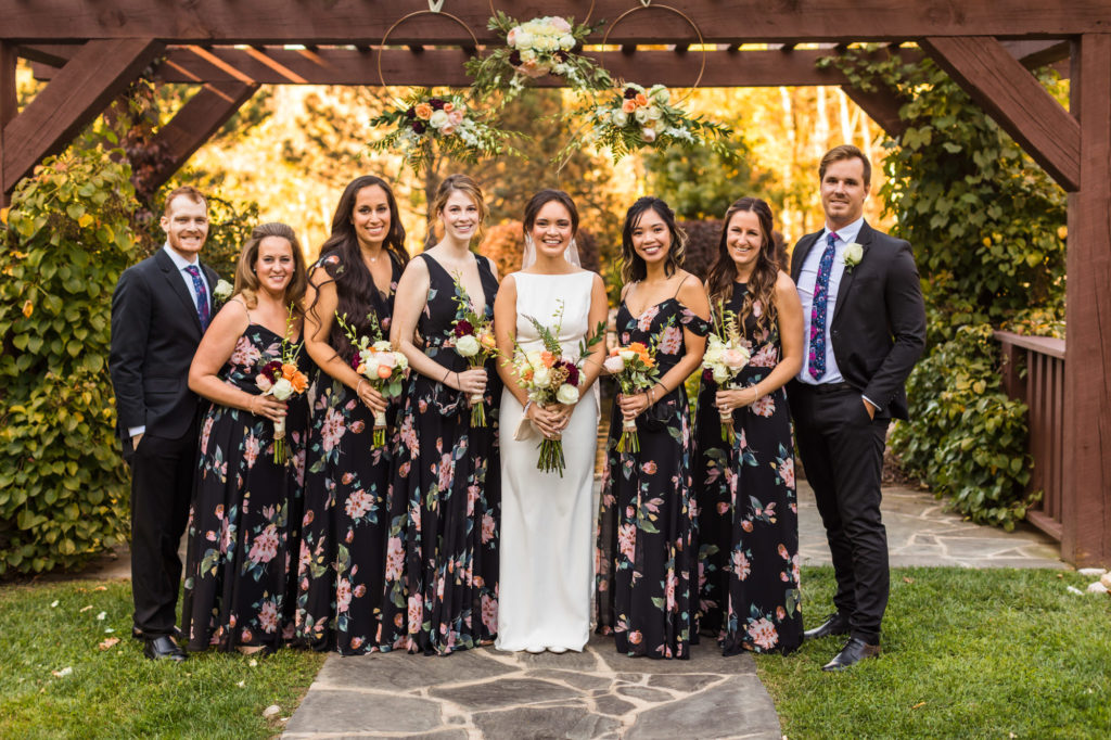 bride smiling with bridesmaids and close family during bridal portraits