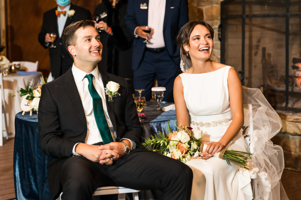 wedding couple laughing and smiling during wedding speeches and toasts