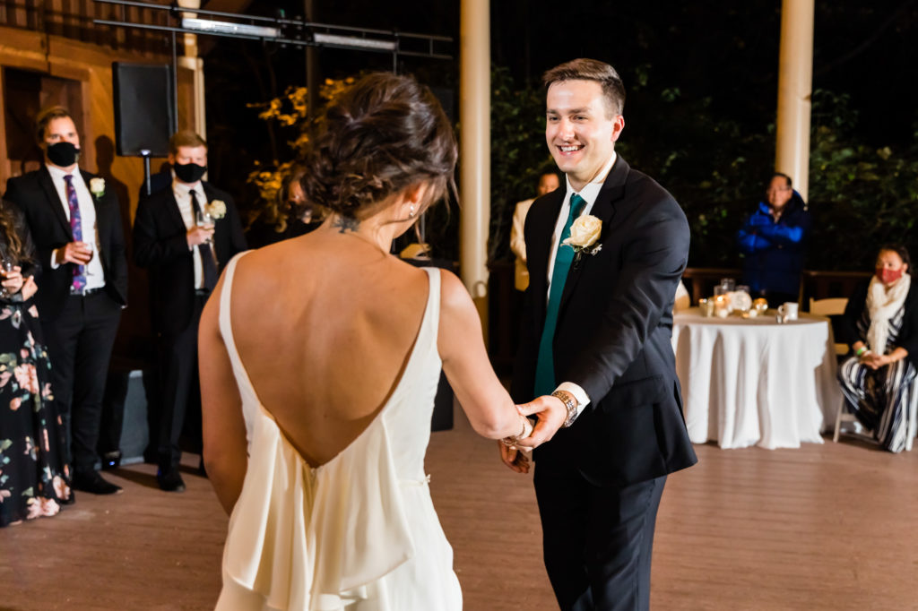 groom holding bride's hands during house mountain inn wedding reception