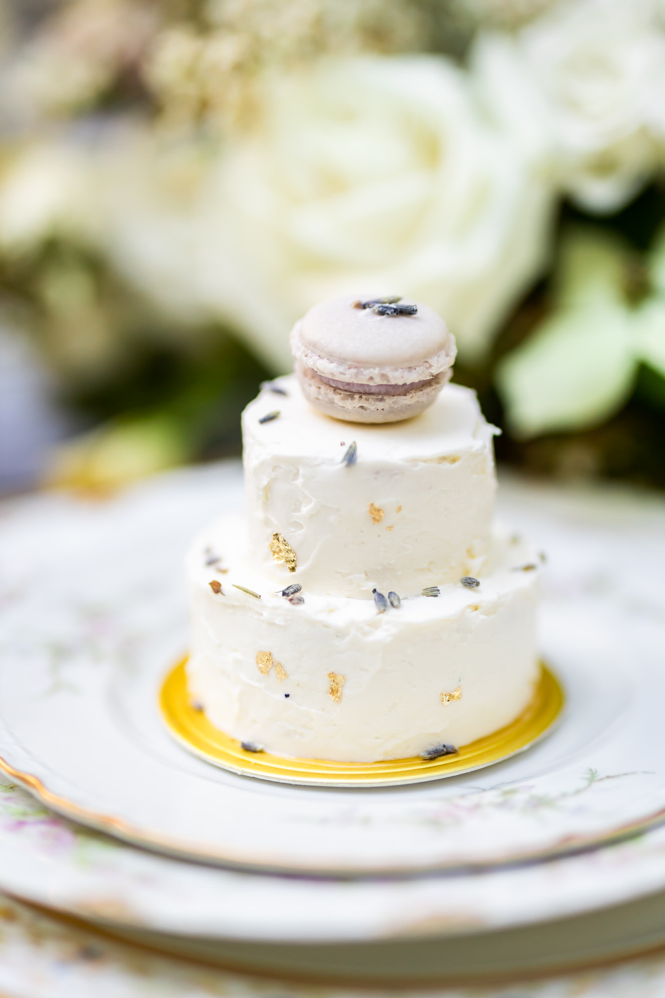 tiny cakes for wedding dessert with macaron sitting on top