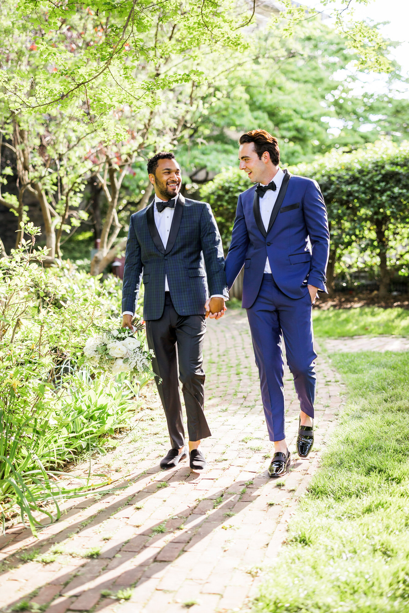 grooms walking hand in hand during outdoor bridal session
