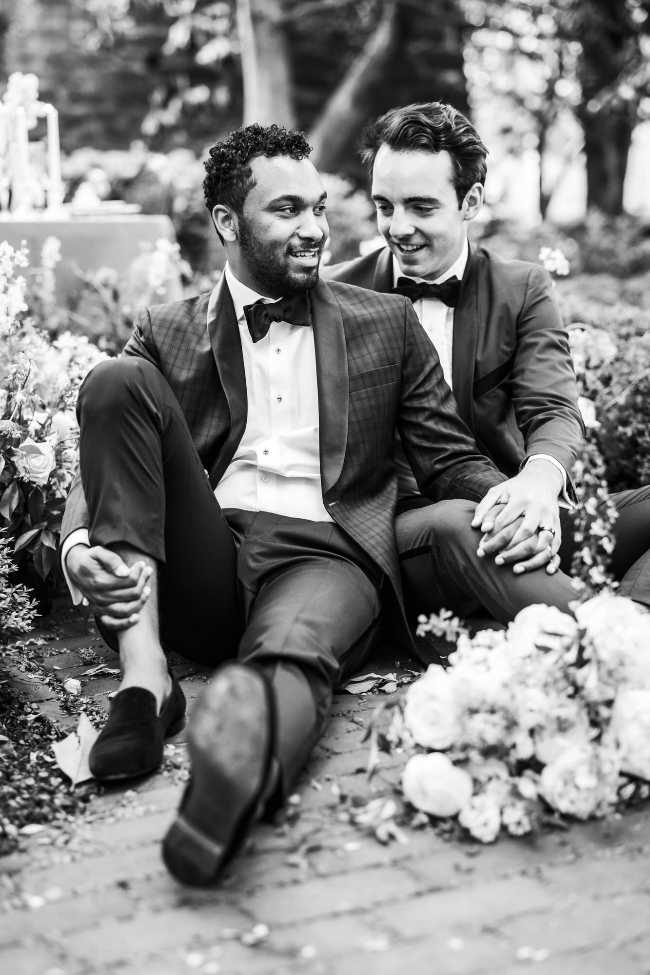 black and white picture of grooms posing on ground during bridals
