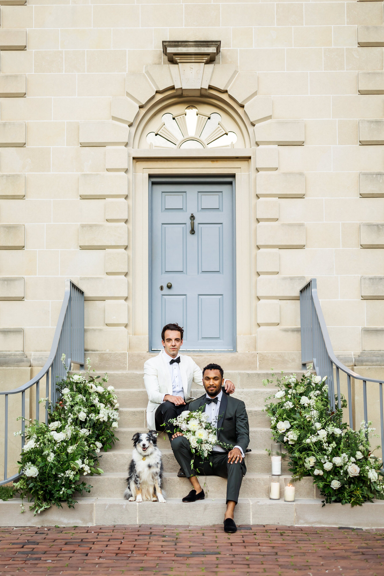 wedding couple sitting on stairs in bridgerton inspired wedding with dog