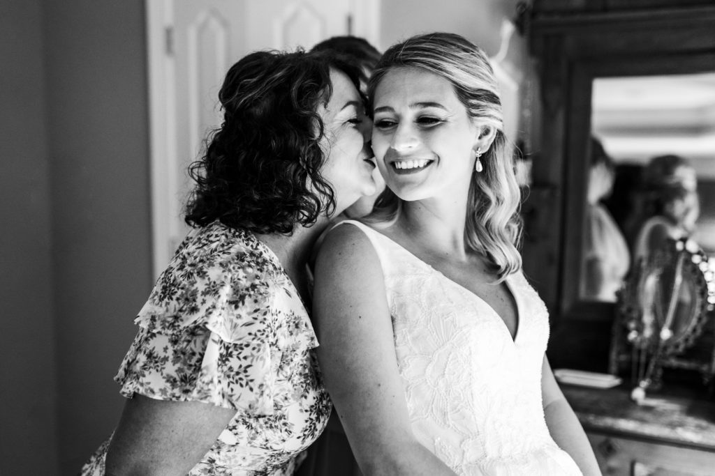 mother kissing bride on cheek on jefferson hotel wedding day