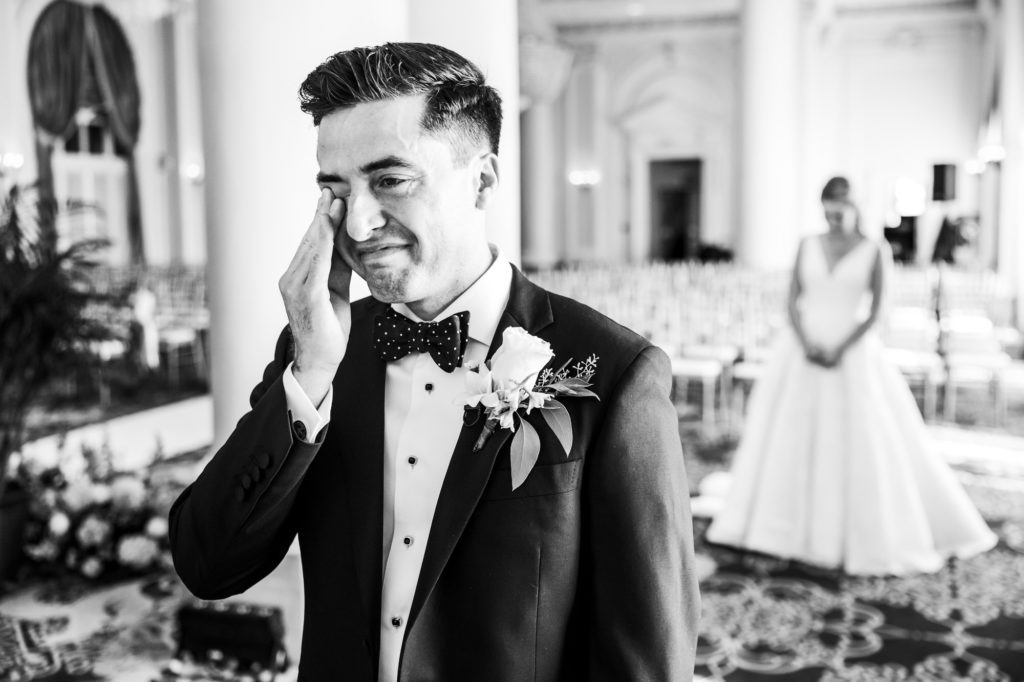 groom starting to cry before seeing bride for first time on wedding day
