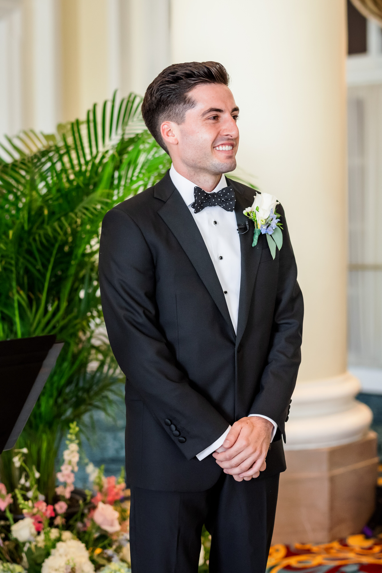 groom waiting at top of aisle for bride to come down 