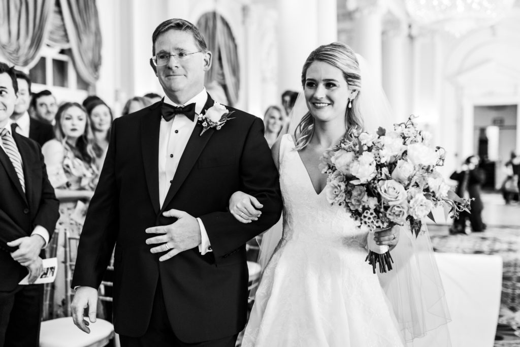 bride being walked down aisle by father