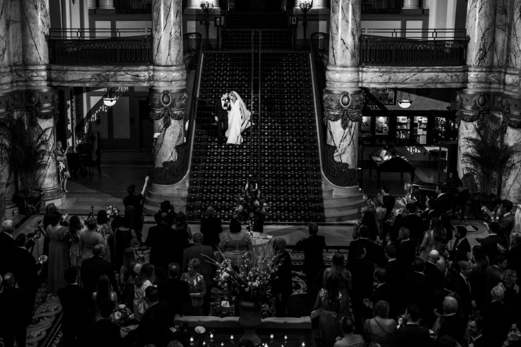 bride and groom walking down stairs of jefferson hotel as husband and wife