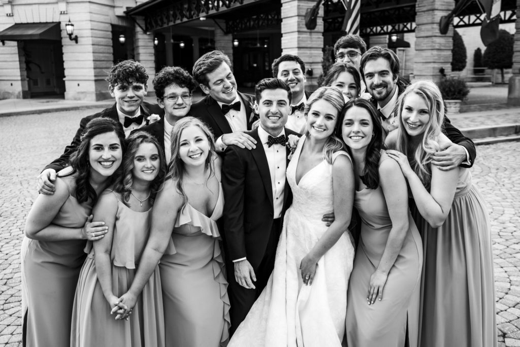 bride and groom celebrating with bridal party and laughing together at jefferson hotel