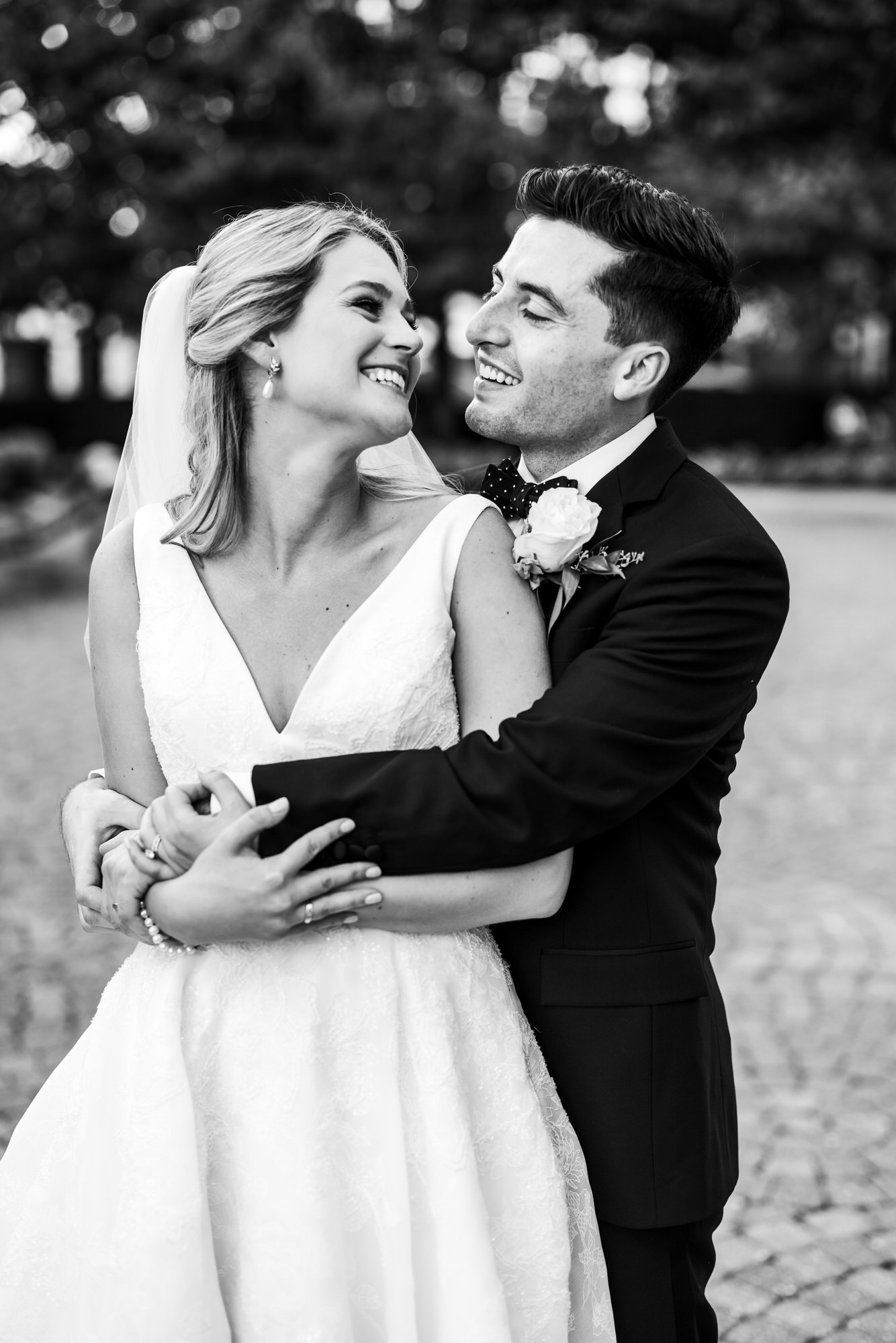 man and woman smiling at one another after wedding