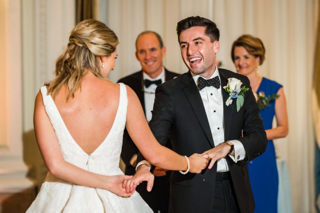 groom holding bride's hands during first dance