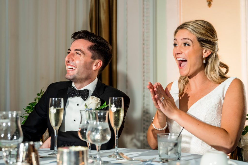 couple laughing during toasts 