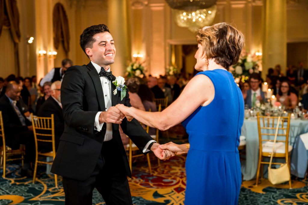 groom dancing with mom on wedding day