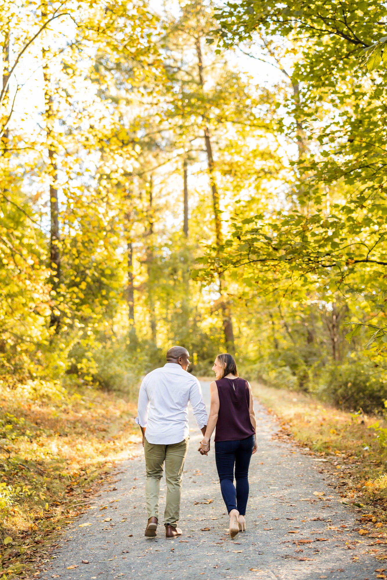 newly engaged couple walking together at montalto fall charlottesville engagement session