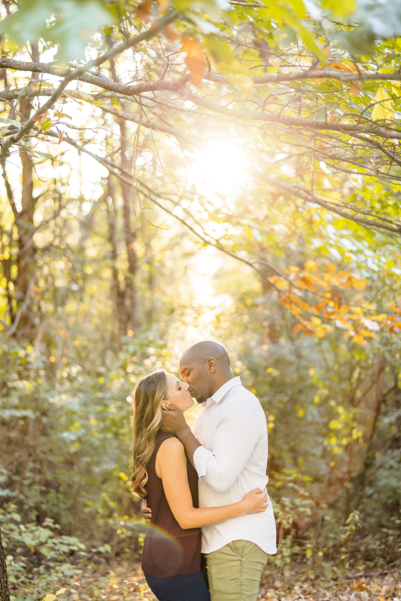newly engaged couple kissing in montalto fall charlottesville engagement session