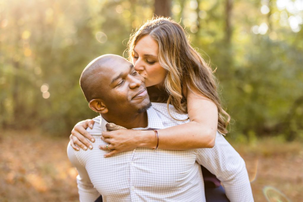 woman on man's back during outdoor engagement session