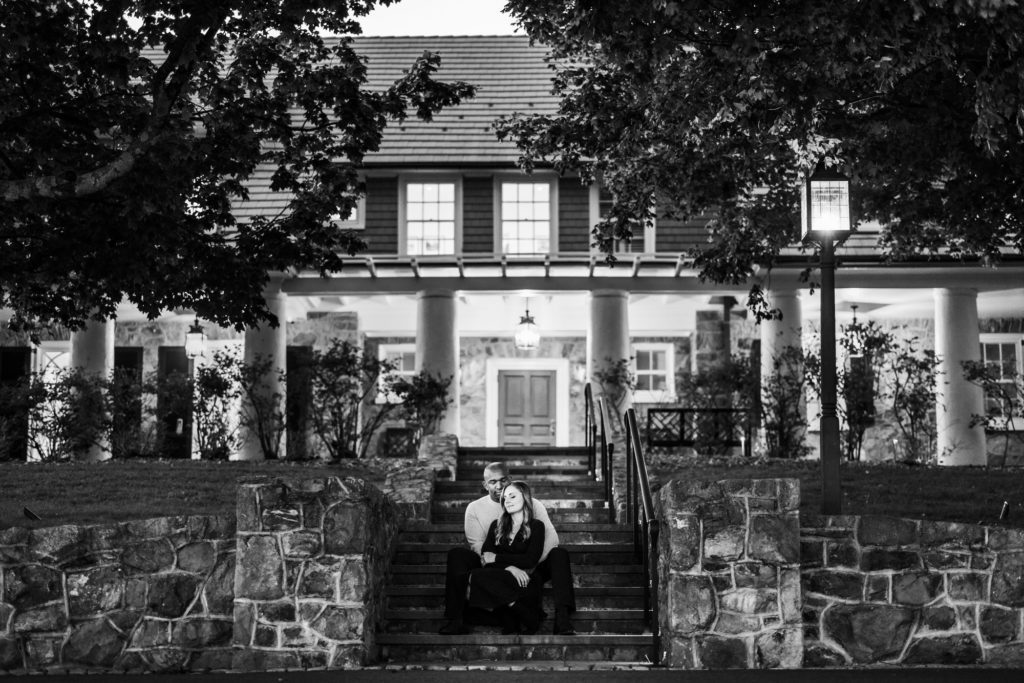 man and woman sitting on steps during outdoor fall charlottesville engagement session