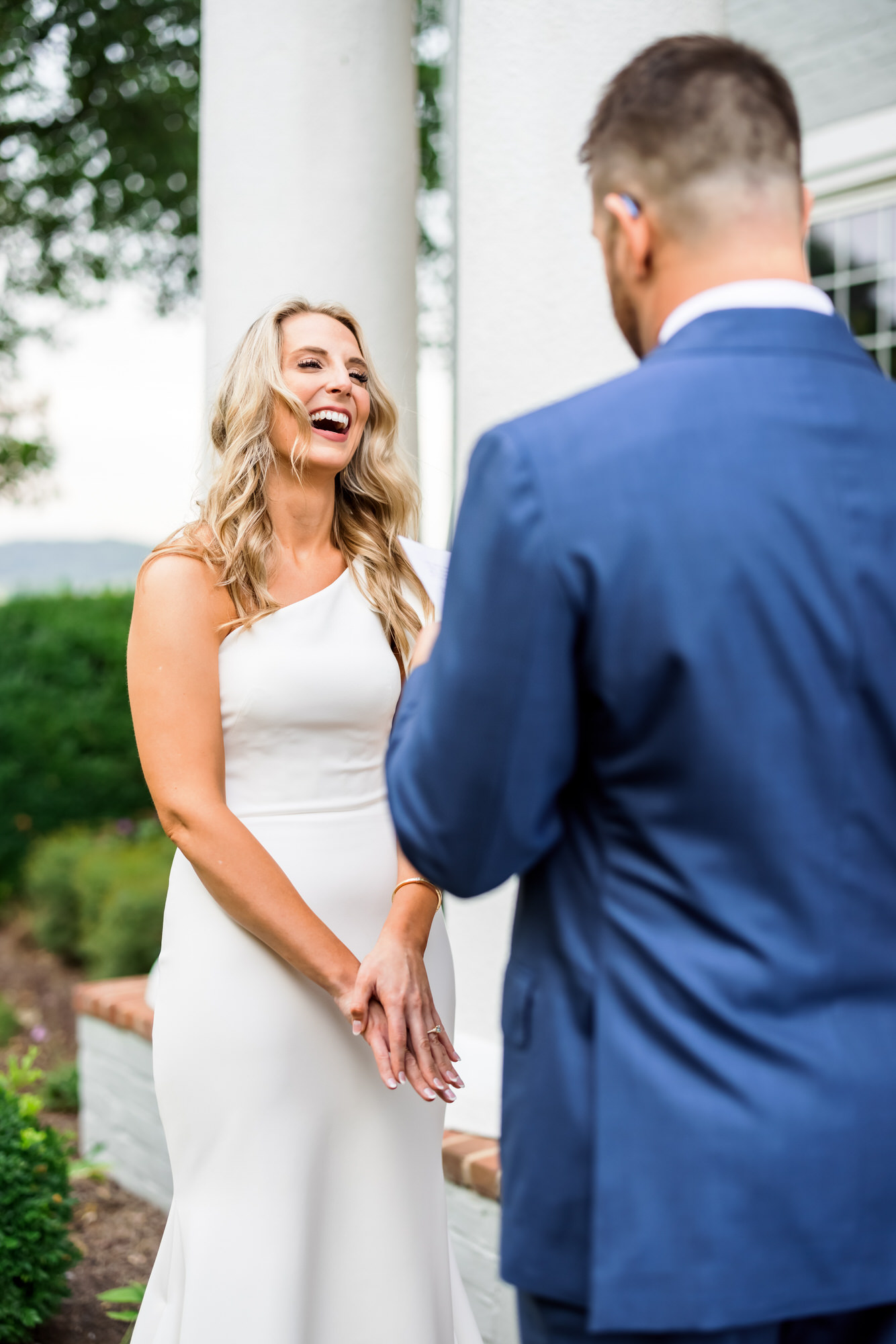 bride laughing during groom's vows