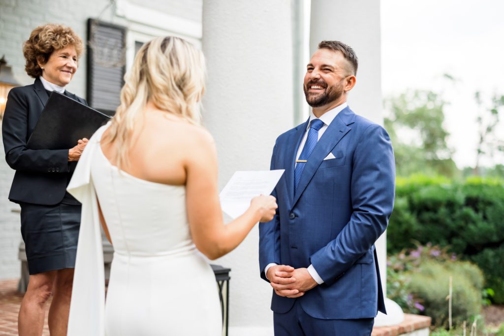 groom laughing during bride's vows