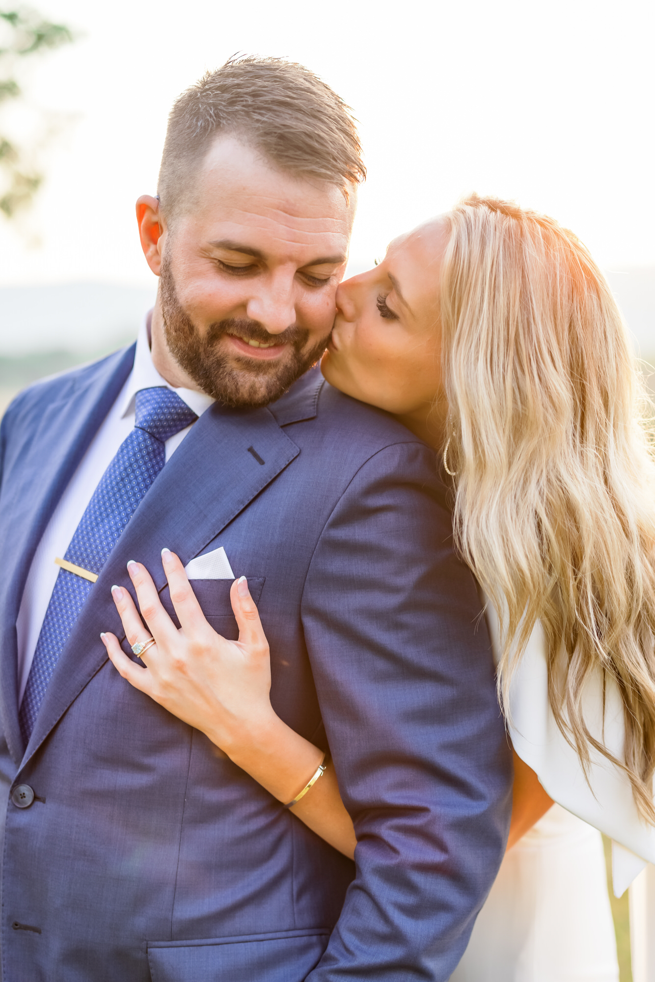 bride kissing groom's forehead during summer charlottesville elopement bridals