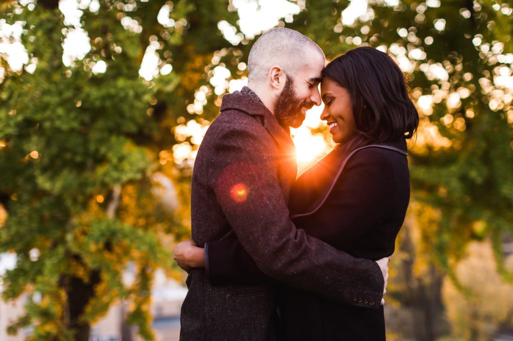 couple snuggling during richmond engagement session at Libby Hill